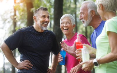 Two older couples laughing after exercise