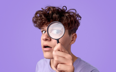Boy looking in magnifying glass