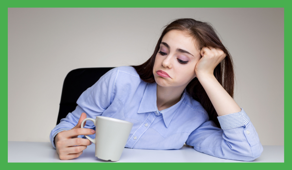 Woman looking at coffee cup