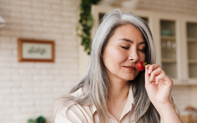 Woman smelling a strawberry