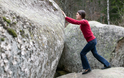 Woman pushing boulder