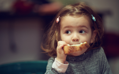 Young girl eating bread